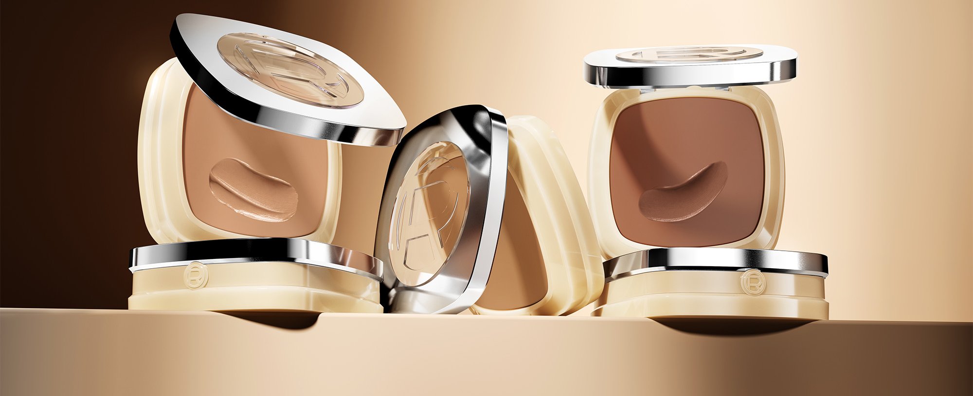 Quatre poudriers carrés de fond de teint L'Oréal dans diverses teintes allant du beige clair au bronzé foncé, présentés sur un fond marron doré chaud.