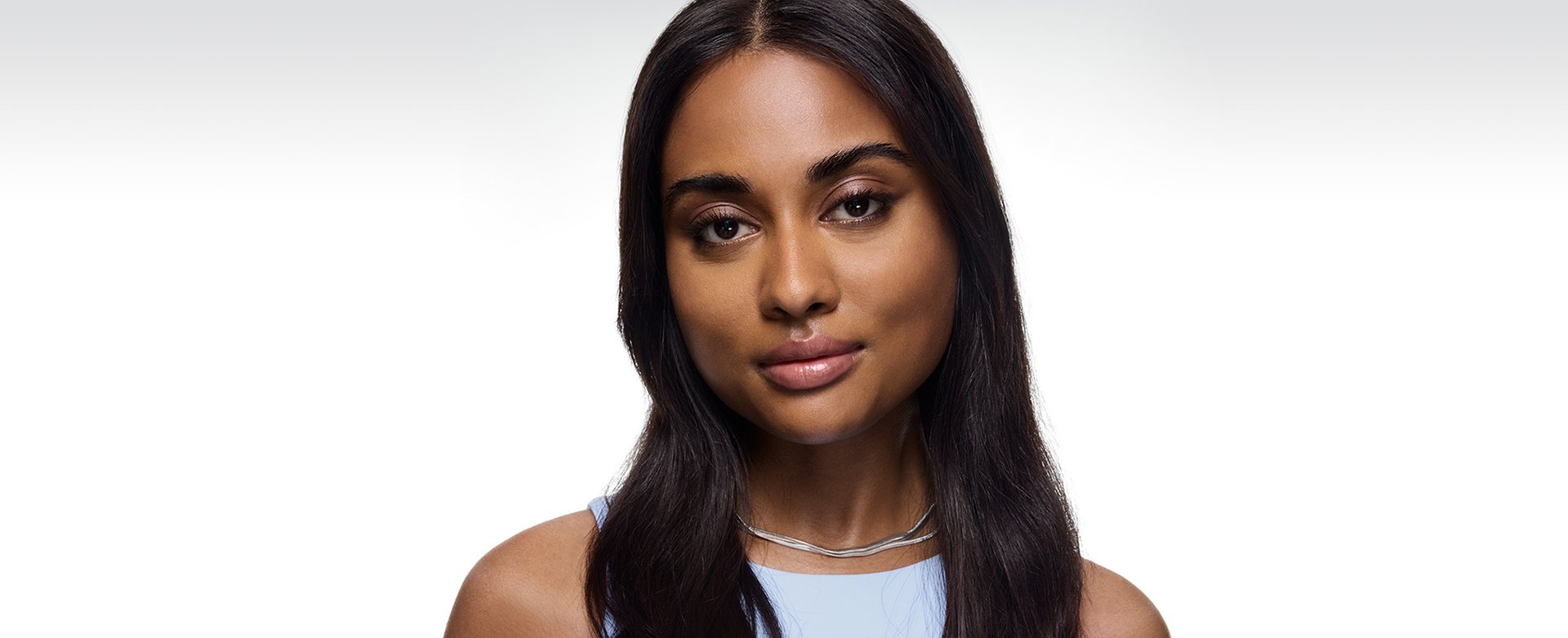 Young woman is facing the camera, with a calm expression and a subtle smile.