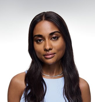 Young woman is facing the camera, with a calm expression and a subtle smile.