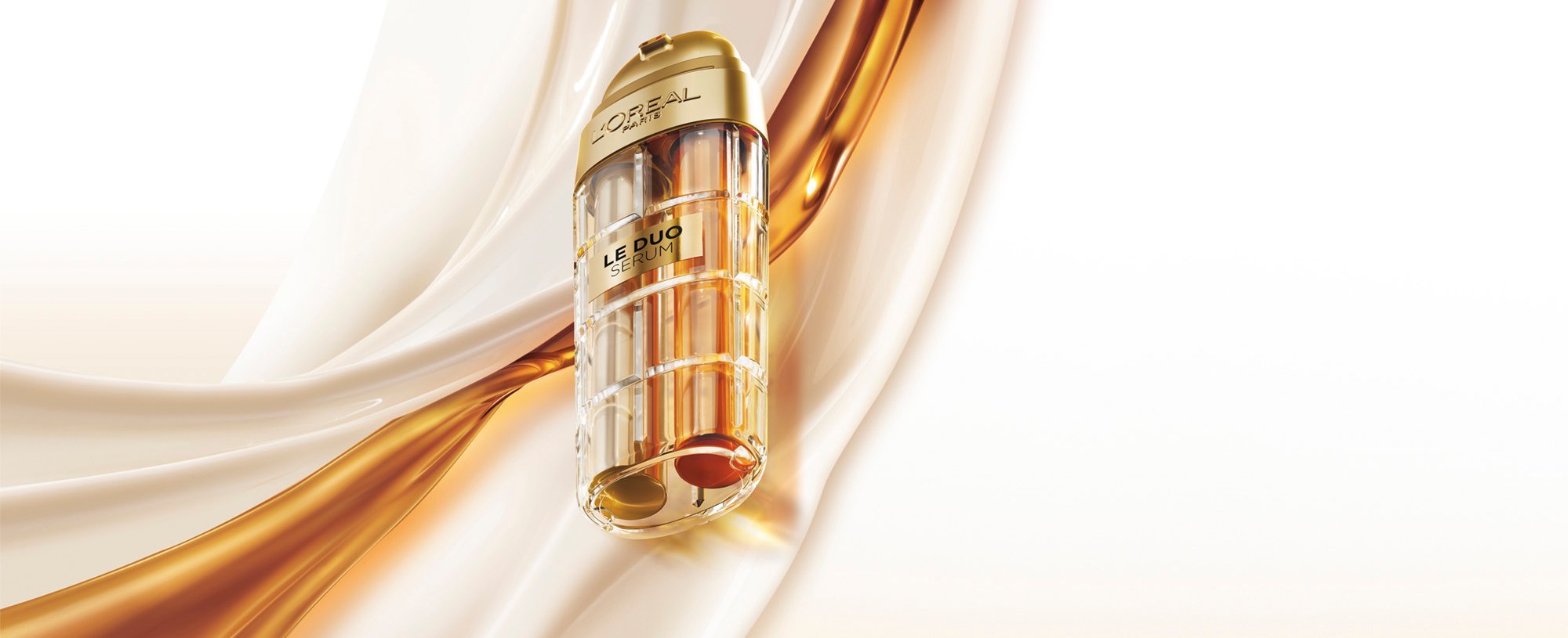 Commercial image of the L'Oréal Paris Le Duo Serum. The luxurious bottle, with gold accents and a transparent body revealing two distinct formulas (one clear and one amber), is presented at a diagonal angle. The background consists of smooth, silky waves of white and golden textures swirling together, symbolizing the power and richness of the serum blend.