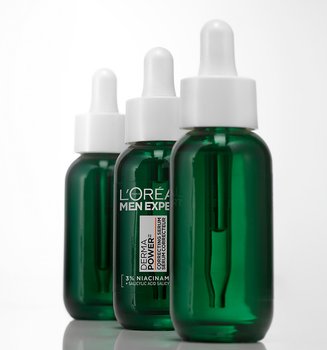 Three green bottles of L'Oréal Men Expert Power Age Correcting Serum with droppers, lined up on a white background.