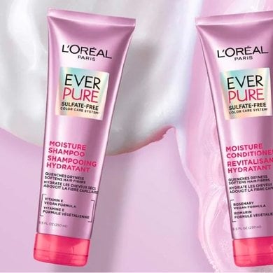 Two pink and purple L'Oréal Paris EverPure sulfate-free shampoo and conditioner bottles are displayed on a light pink and purple background with foamy or creamy textures