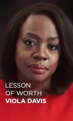 L’Oréal Paris ambassador Viola Davis in a red dress for her 'Lesson of Worth' video, delivering an inspiring message on self-esteem and personal value.