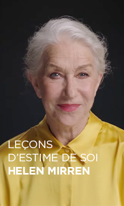 Portrait de l'actrice Helen Mirren sur un fond sombre. Elle a les cheveux blancs courts et coiffés, et sourit avec douceur face à l'objectif. Elle porte une chemise boutonnée en soie jaune éclatant. Un texte blanc en bas de l'image indique : « LEÇONS D’ESTIME DE SOI HELEN MIRREN »