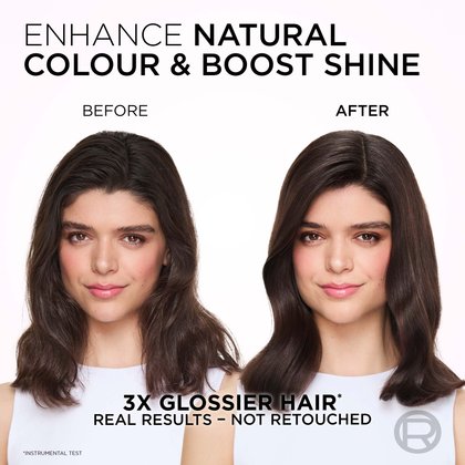 A split image showing a woman's hair and facial expression before and after a treatment designed to enhance natural color and boost shine. On the left, labeled "BEFORE," she has long, wavy, dark brown hair that appears somewhat dry and less vibrant, with a neutral expression. On the right, labeled "AFTER," her hair is a richer, deeper dark brown with a noticeable glossy sheen and more defined waves. She is smiling gently, and her complexion is fresh with a subtle pink flush. The text at the top reads: "ENHANCE NATURAL COLOUR & BOOST SHINE." Below the images, it states: "3X GLOSSIER HAIR*" and "REAL RESULTS - NOT RETOUCHED," with an asterisk indicating "*INSTRUMENTAL TEST."
