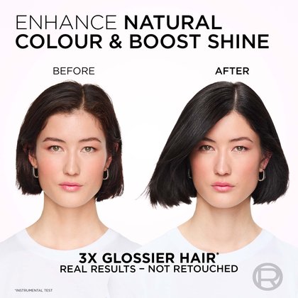 A split image showing a woman's hair and face before and after a treatment designed to enhance natural color and boost shine. On the left, labeled "BEFORE," she has natural dark brown hair with a subtle sheen. On the right, labeled "AFTER," her hair appears significantly darker, a rich black, and noticeably glossier, reflecting light more intensely. Her complexion and expression remain consistent between both images, with a neutral gaze and subtle pink blush. The text above reads: "ENHANCE NATURAL COLOUR & BOOST SHINE." Below the images, it states: "3X GLOSSIER HAIR*" and "REAL RESULTS - NOT RETOUCHED," with an asterisk indicating "*INSTRUMENTAL TEST."