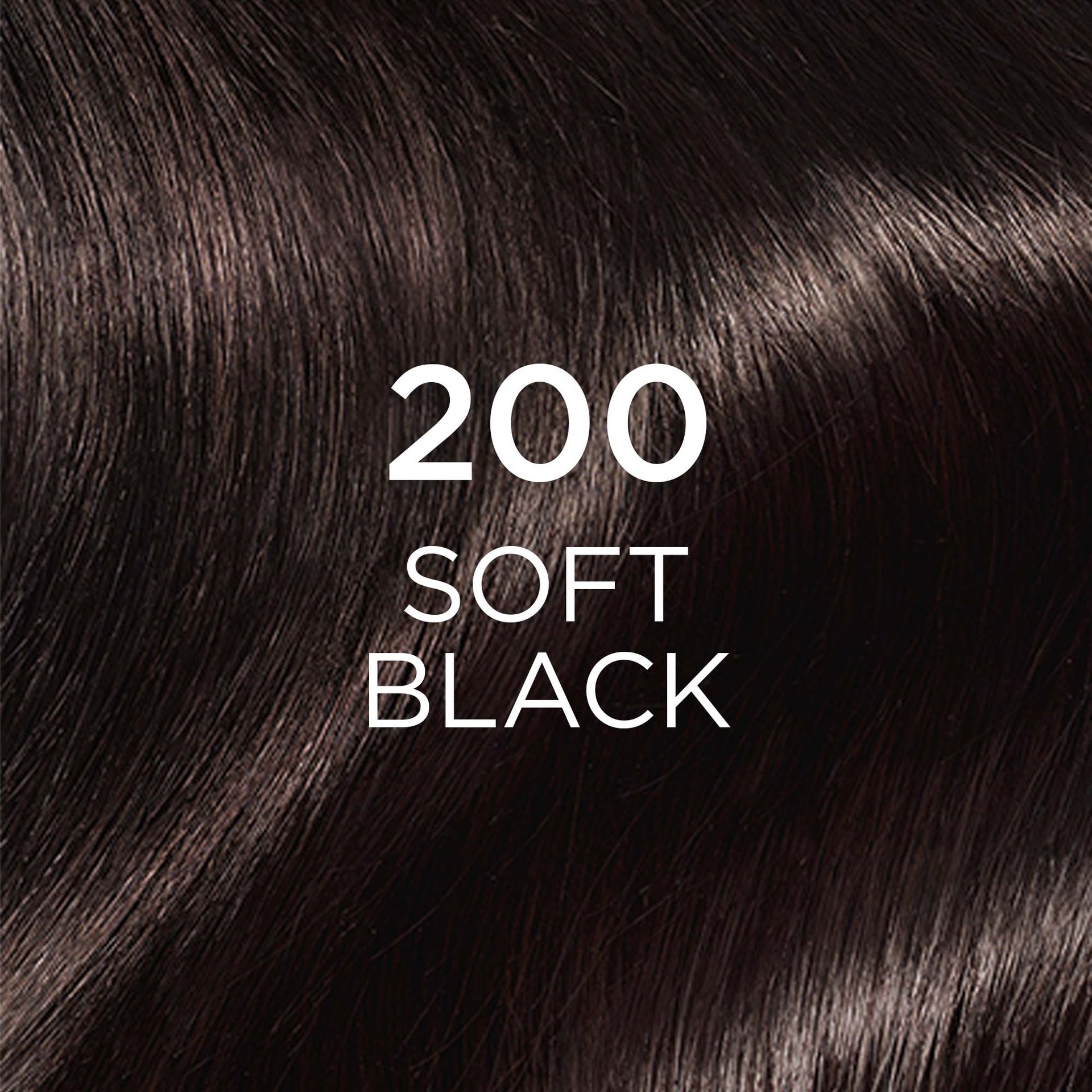 A close-up shot of smooth, dark hair, indicating the color shade "200 SOFT BLACK." The hair shows a subtle, soft black hue with natural highlights.