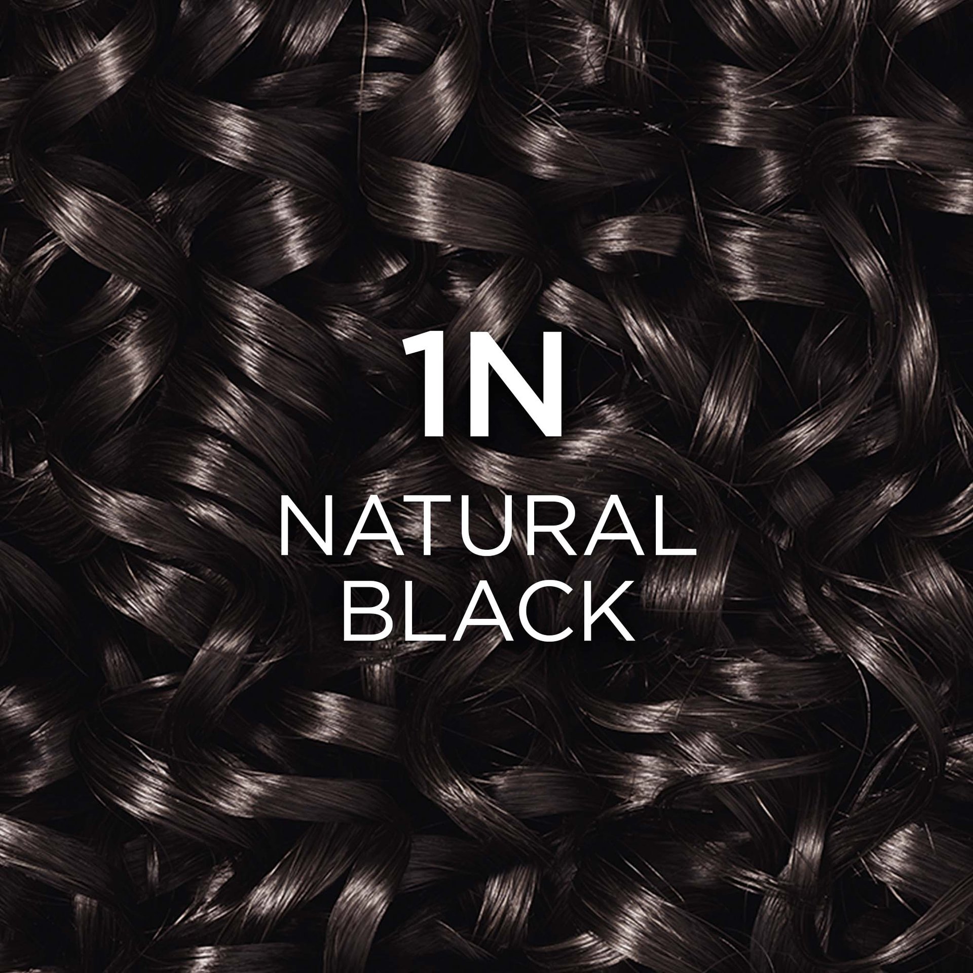 Close-up of very dark, curly natural black hair, with white text "1N NOIR NATUREL" (meaning "1N Natural Black") overlaid.