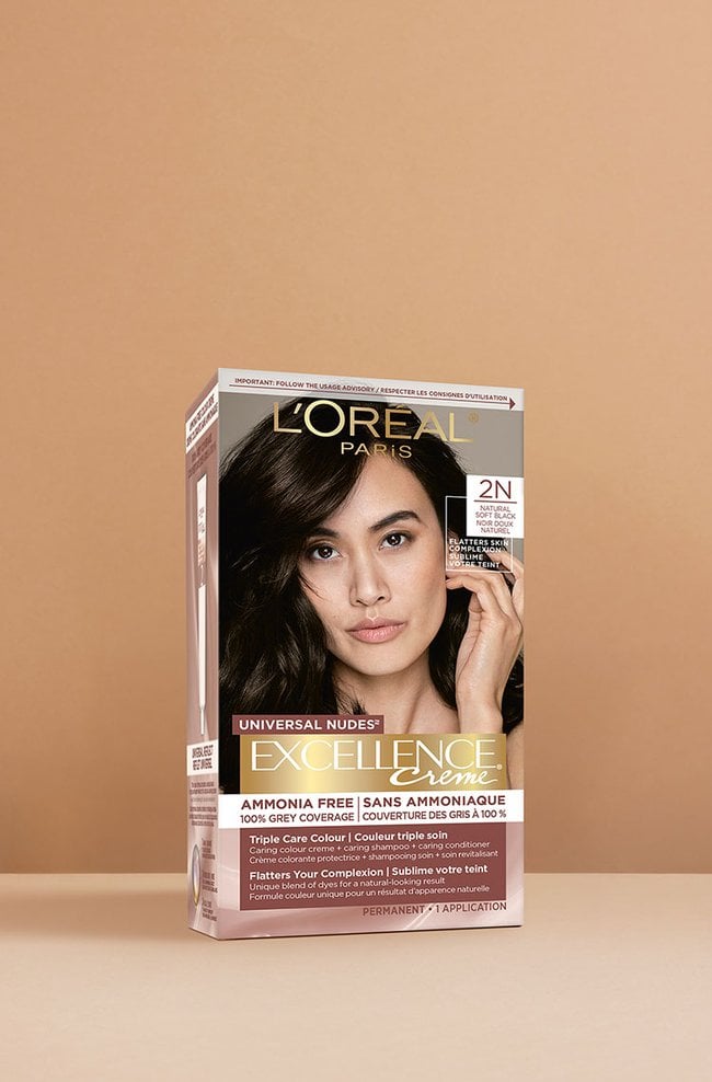 L'Oréal Excellence Crème Universal Nudes 2N Soft Black hair dye box, featuring a smiling woman with sleek, shiny dark black hair.