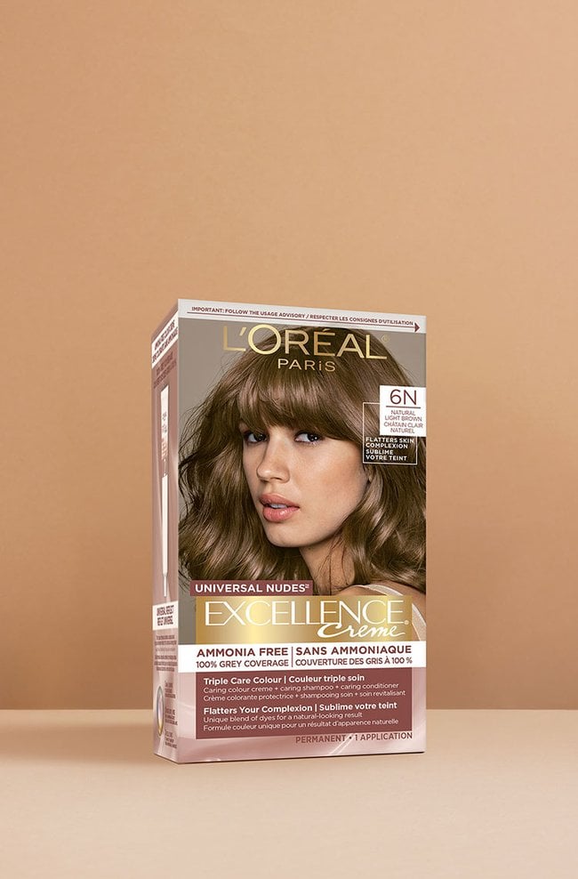 L'Oréal Excellence Crème Universal Nudes 6N Medium Brown hair dye box, featuring a smiling woman with smooth, medium brown hair styled in soft waves.