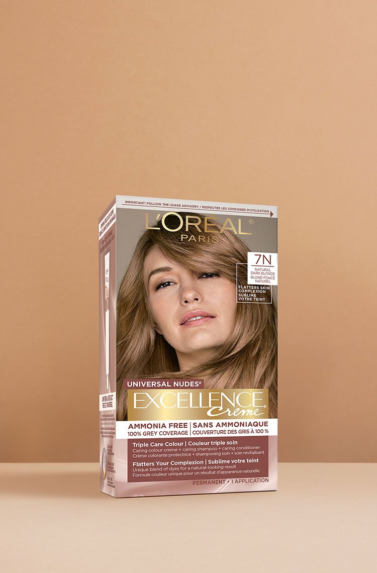 L'Oréal Excellence Crème Universal Nudes 7N Golden Blonde hair dye box, featuring a smiling woman with smooth, medium-length golden blonde hair.