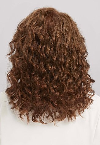 Back view of the same person after a hair color treatment; the curls are now a uniform, warm brown shade, maintaining their volume and texture.