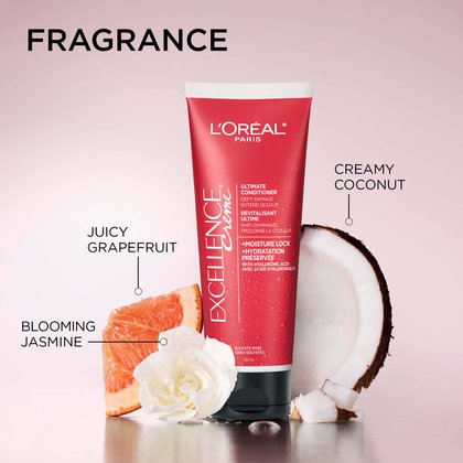 L’Oréal Paris Excellence Crème Ultimate Conditioner tube on a reflective surface, surrounded by fragrance ingredients.