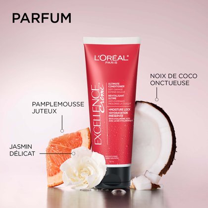 Tube de revitalisant ultime L'Oréal Paris Excellence Crème sur une surface réfléchissante, entouré d'ingrédients évocateurs de parfum : une tranche de pamplemousse juteux, une fleur de jasmin en fleurs et une moitié de noix de coco crémeuse. Titre : Fragrance.