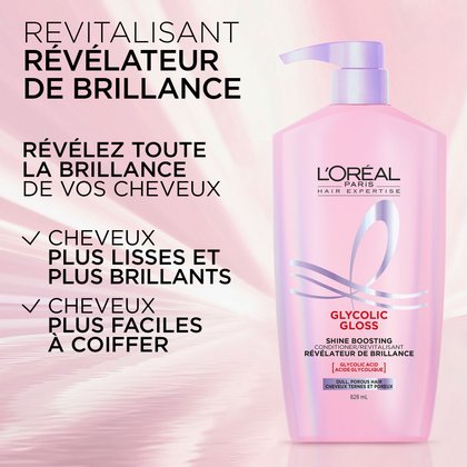 Une bouteille de l'après-shampooing révélateur de brillance L'Oréal Paris Glycolic Gloss est placée à côté d'un modèle vu de dos, mettant en valeur ses longs cheveux foncés, incroyablement brillants et lisses. Le texte "GET NEXT-LEVEL SHINE YOU'RE WORTH IT." est visible en bas de l'image.