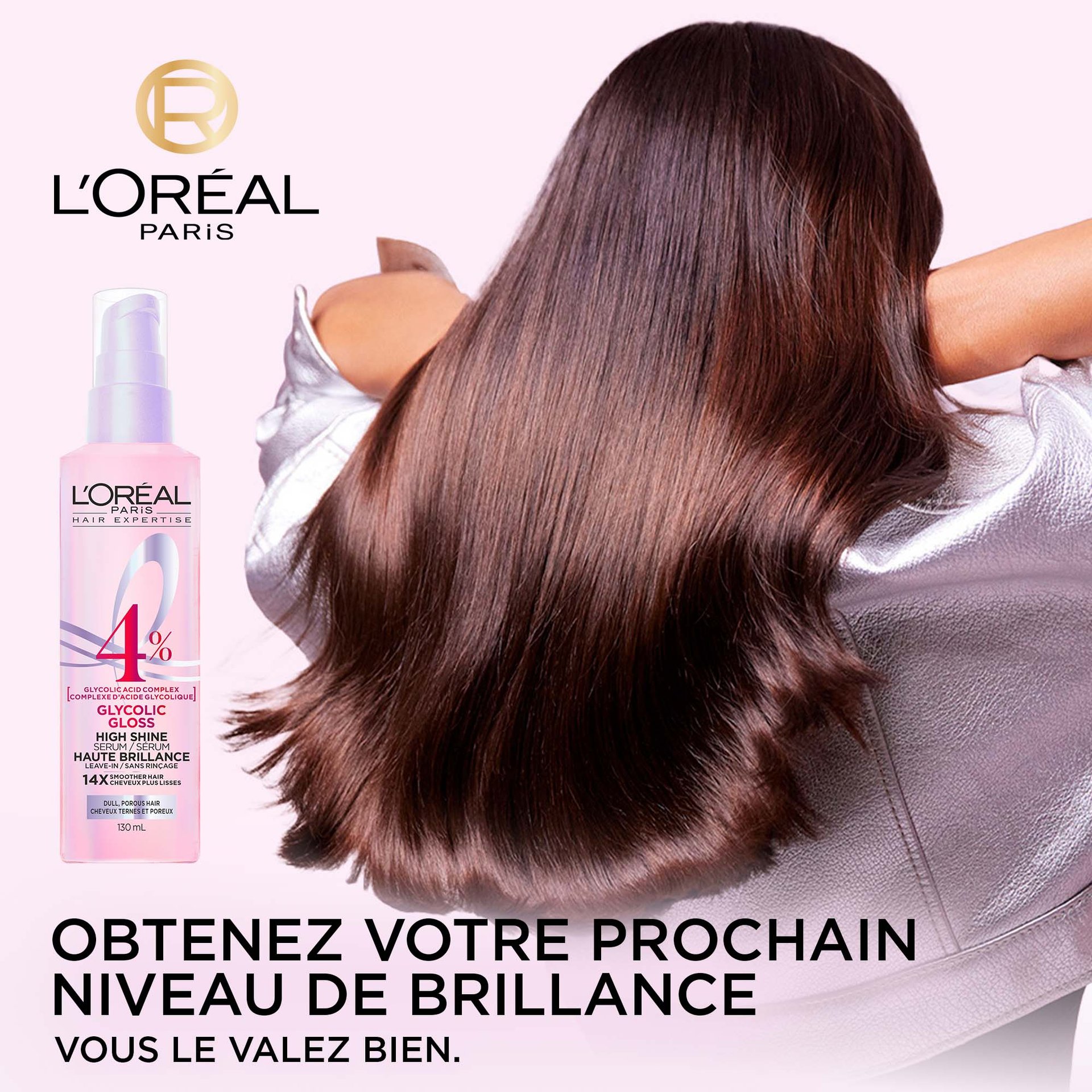 Une bouteille de sérum brillance L'Oréal Paris Glycolic Gloss est placée à côté d'un modèle vu de dos, mettant en valeur ses longs cheveux foncés, incroyablement brillants et lisses. Le texte "GET NEXT-LEVEL SHINE YOU'RE WORTH IT." est visible en bas de l'image.