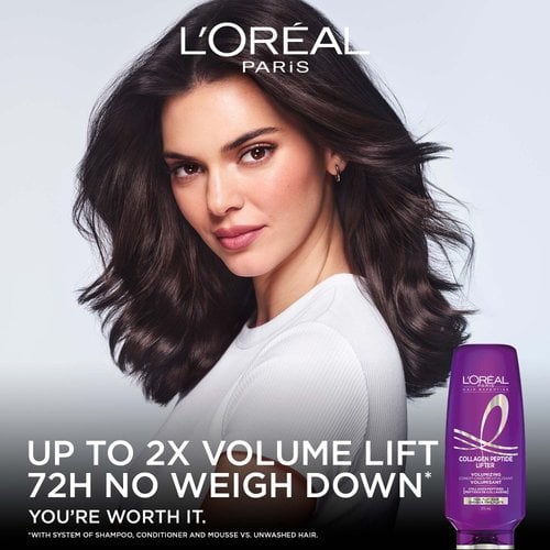 A female model with voluminous, wavy dark brown hair posing on a dark background next to a bottle of Hair Expertise Collagen Peptide Lifter shampoo, featuring the text "UP TO 2X VOLUME LIFT, 72H NO WEIGH DOWN".