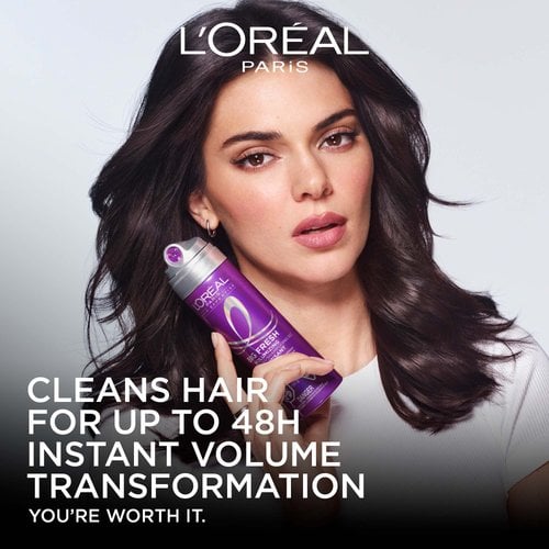 Front view of L'Oréal Paris spokesperson Kendall Jenner with voluminous dark hair, holding the purple Big Fresh Volumizing Dry Shampoo can. Text reads: 'Cleans hair for up to 48H. Instant volume transformation.'