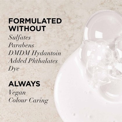 A shot of the lightweight liquid texture next to the "Formulated Without" list: Sulfates, Parabens, DMDM Hydantoin, Added Phthalates, and Dye. Highlights that the formula is always Vegan and Colour Caring.