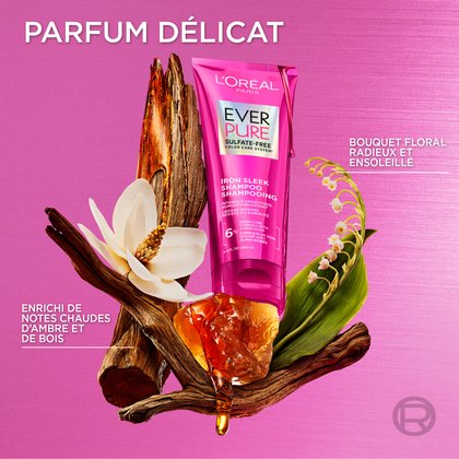Composition artistique du tube de shampooing entouré d'ingrédients aromatiques comme des gousses de vanille et des orchidées, intitulée « Parfum délicat ».