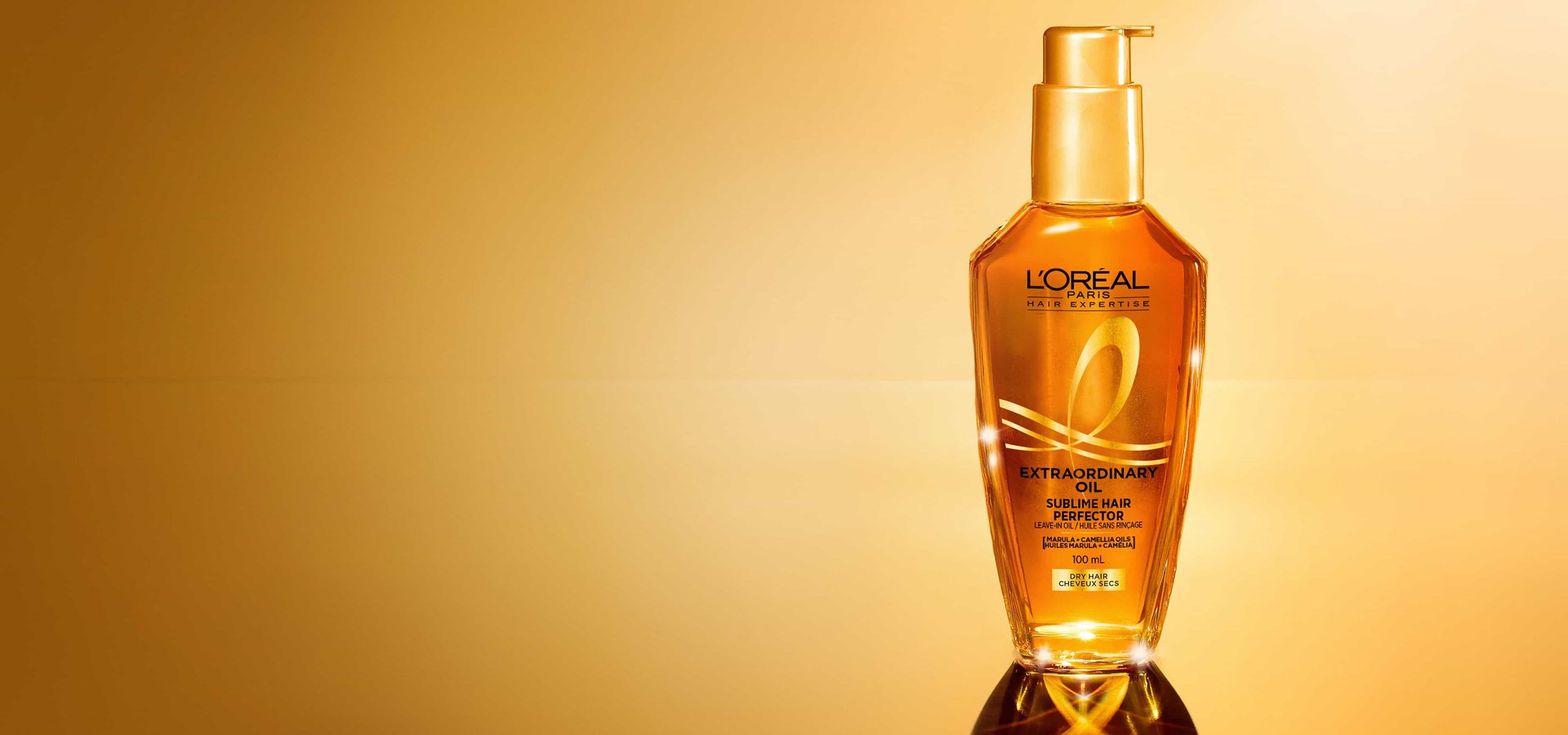 A single bottle of L'Oréal Paris Hair Expertise Extraordinary Oil Sublime Hair Perfector on a golden gradient background