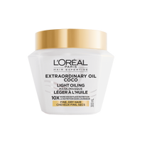 Un plan de studio du pot blanc de L'Oréal Paris Hair Expertise Extraordinary Oil Masque Léger à l’Huile de Coco sur fond blanc, muni d'un couvercle doré brillant.