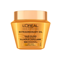Un plan de studio du pot doré translucide de L'Oréal Paris Hair Expertise Extraordinary Oil Masque Capillaire Bain d'Huile sur fond blanc, muni d'un couvercle doré brillant.
