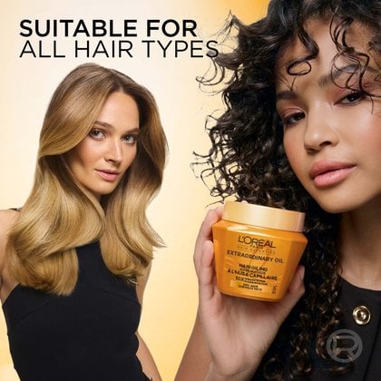 Side-by-side portrait of two women, one with blonde wavy hair and one with dark curly hair. Each holds the gold L'Oréal Paris Extraordinary Oil mask jar, next to the text "Suitable for all hair types".