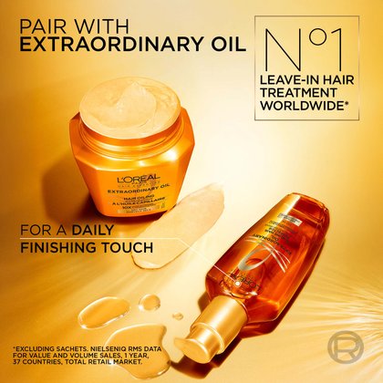 Close-up shot of the open gold mask jar next to the tilted gold leave-in oil bottle on a warm-toned background. Text overlays: "Pair with Extraordinary Oil, No. 1 leave-in hair treatment worldwide, for perfect finishing touch".