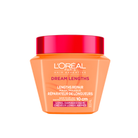 Un plan de studio du pot orange de L'Oréal Paris Hair Expertise Dream Lengths Masque Réparateur de Longueurs sur fond blanc, muni d'un couvercle rose.
