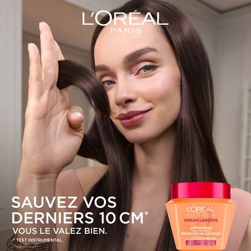 Une femme aux cheveux longs noirs et brillants passant ses doigts dans ses longueurs. À sa gauche, le texte indique « Sauvez vos 10 derniers centimètres » avec le pot de masque orange en bas.