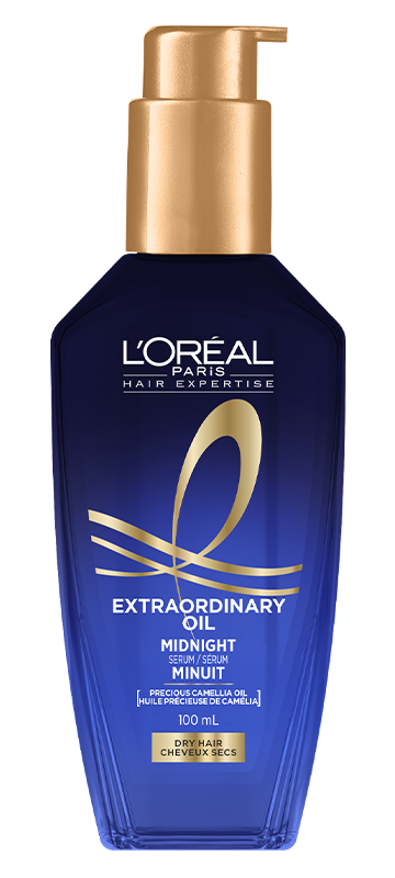 A studio shot of the deep blue translucent bottle of L'Oréal Paris Hair Expertise Extraordinary Oil Midnight Hair Serum on a clean white background. The bottle has a shiny gold pump dispenser and features golden ribbons and details on the front label.