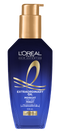 Un plan de studio du flacon bleu foncé translucide de L'Oréal Paris Hair Expertise Extraordinary Oil Sérum Nuit Cheveux sur fond blanc. Le flacon possède une pompe dorée brillante et arbore des détails et des rubans dorés sur son étiquette.