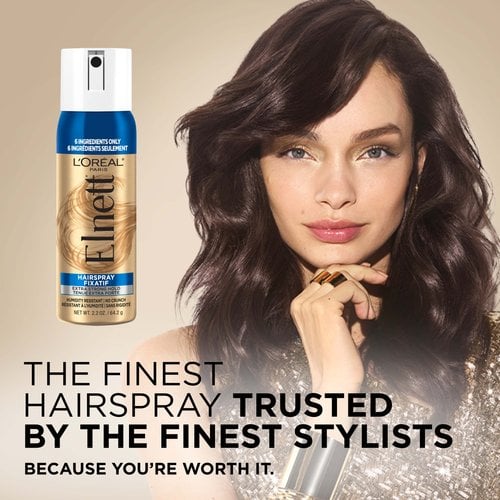 A women with a blowout and a Elnett hair spray