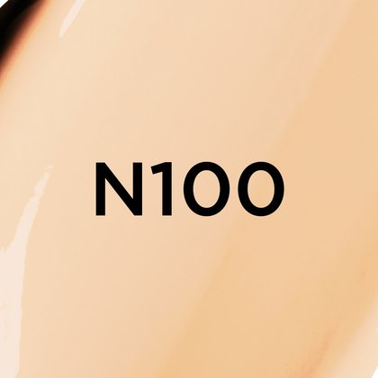 A close-up of a light beige, creamy foundation or cosmetic texture with neutral to slightly pink undertones, featuring the bold black text 'N100' centered on the image, likely indicating a product shade.