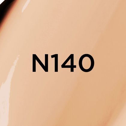 A close-up of a light to medium beige, creamy foundation or cosmetic texture with neutral to slightly warm undertones, featuring the bold black text 'N140' centered on the image, likely indicating a product shade