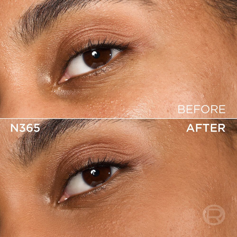 A split image showing a before and after comparison of a person's under-eye and cheek area with medium to dark skin tone and brown eyes. The top section, labeled 'BEFORE', displays skin with visible texture, pores, and slight unevenness in tone under the eye, along with light eye makeup featuring golden-brown eyeshadow. The bottom section, labeled 'N365' and 'AFTER', shows the same facial area with noticeably more even-toned, smoother skin, and reduced imperfections, following the application of a cosmetic product. The eye makeup remains visible. A subtle 'R' logo is also visible in the bottom right of the 'AFTER' portion