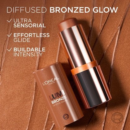 An open L'Oréal Lumi Bronze stick, showcasing its golden-bronze barrel and product, resting on a textured bronze swatch. Accompanying text highlights 'DIFFUSED BRONZED GLOW' and features 'ULTRA SENSORIAL', 'EFFORTLESS GLIDE', and 'BUILDABLE INTENSITY'