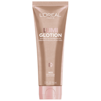 A product shot of a light pink, squeeze tube of L'Oréal Paris Lumi Glotion, Natural Glow Enhancer in shade 903 Light Glow, 3.3 fl. oz. / 100 ml. The tube has a light pink cap and features the brand and product name prominently.