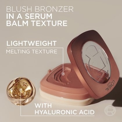 Close-up of the creamy, round blush bronzer product in its container, accompanied by hydration droplets and text highlighting "BLUSH BRONZER IN A SERUM BALM TEXTURE" and "WITH HYALURONIC ACID".