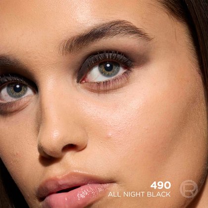 A close-up beauty shot of a model's face looking at the camera, showcasing a finished black smokey eye makeup look.