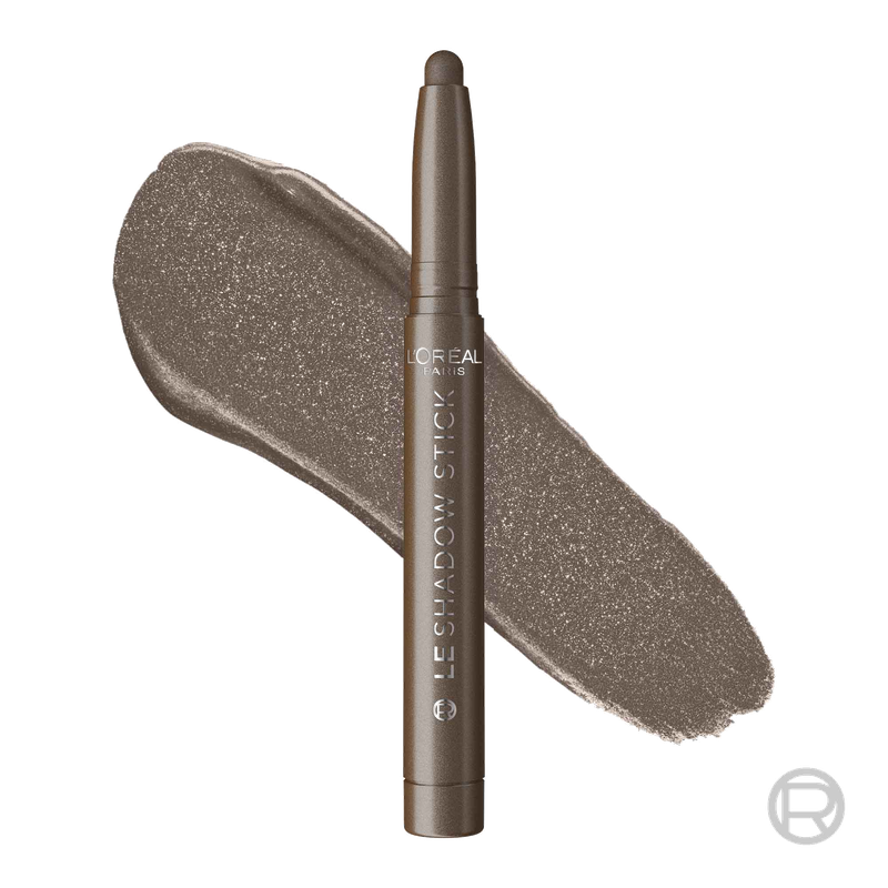 A professional product packshot of a L'Oréal Shadow Stick in 'Celestial Taupe' standing upright next to a smooth, thick swipe of the shimmering taupe pigment.