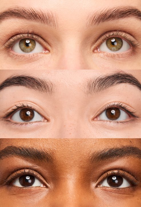 Advertising montage featuring three pairs of eyes of different skin tones in the center, showcasing natural lashes without mascara. The visual is framed by artistic close-ups of the Telescopic Extensionist mascara tube in a shiny silver chrome finish, creating a contrast between the natural look and the product's high-tech aesthetic.