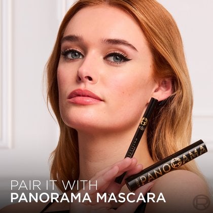A model with black winged eyeliner and a subtle makeup look, holding a black L'Oréal Paris "Haute Precision Liquid Eyeliner" and a black "Panorama Mascara." Text at the bottom states: "PAIR IT WITH PANORAMA MASCARA."