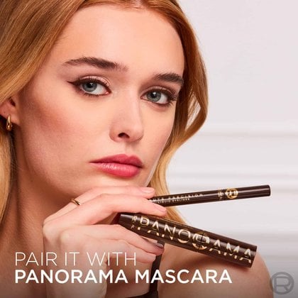A model with brown eyeliner and a subtle makeup look, holding a brown L'Oréal Paris "Haute Precision Liquid Eyeliner" and a gold "Panorama Mascara." Text at the bottom states: "PAIR IT WITH PANORAMA MASCARA.