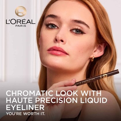 A model with brown winged eyeliner looks directly at the camera, holding the dark brown L'Oréal Paris Haute Precision Liquid Eyeliner. The L'Oréal Paris logo is in the top left corner, and the text "CHROMATIC LOOK WITH HAUTE PRECISION LIQUID EYELINER YOU'RE WORTH IT." is at the bottom.