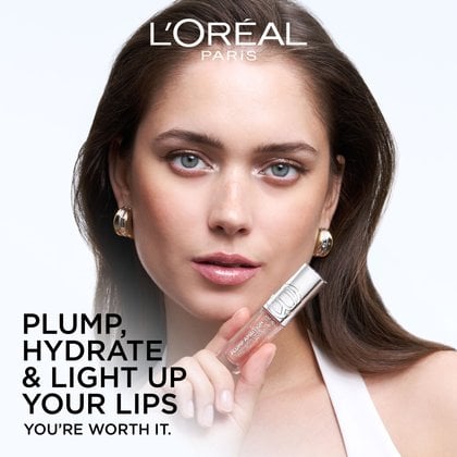 Beauty portrait of a model holding the Plump Ambition lip gloss, featuring the text: "Plump, Hydrate & Light Up Your Lips."