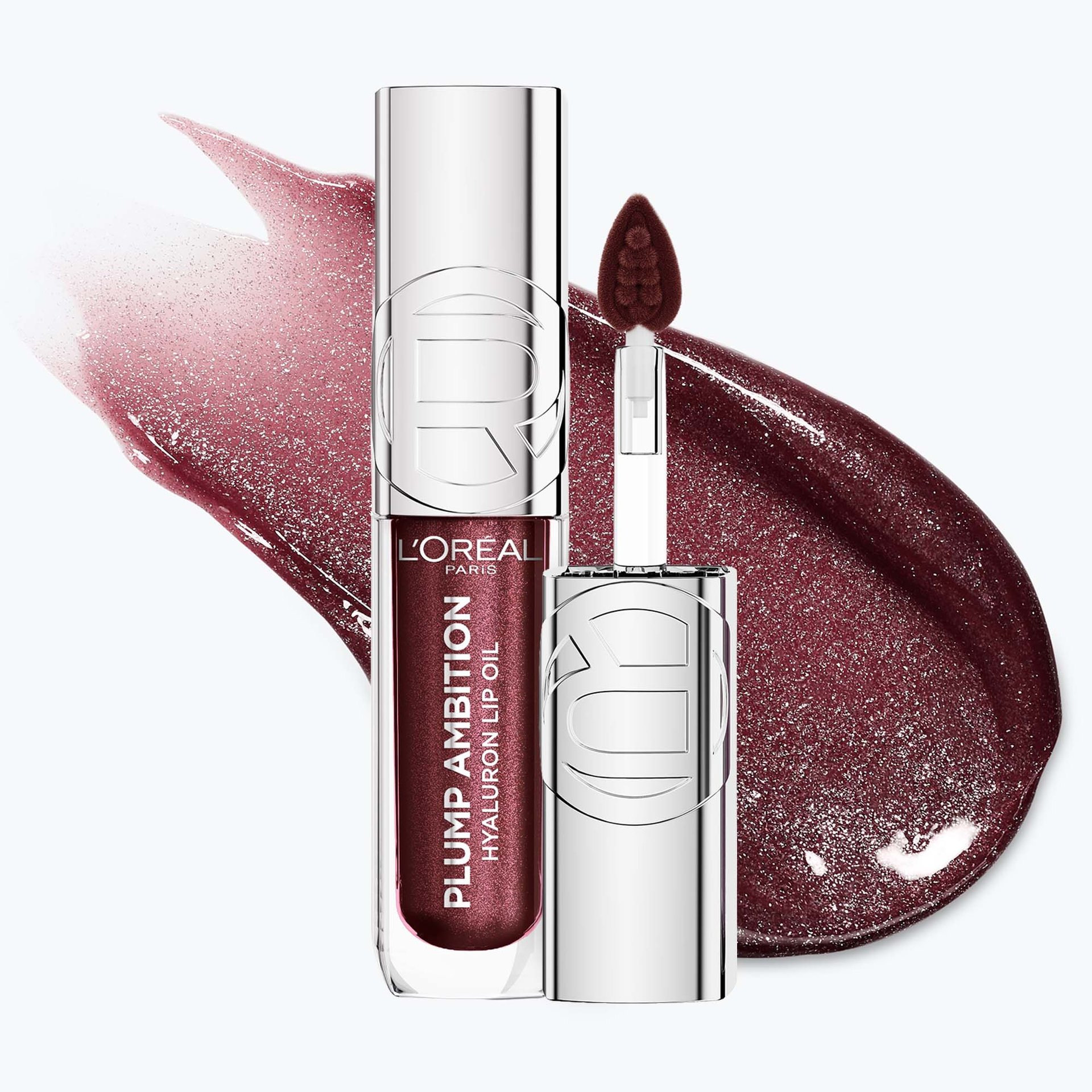Photo de produit professionnelle de l'huile à lèvres Plump Ambition dans la teinte « 124 Ruby Lights », présentée à la verticale.