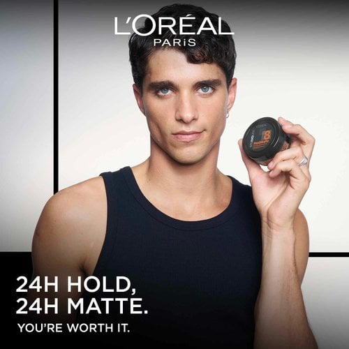 L'Oréal Paris male model holding a Studio Line styling product, with text reading "24H HOLD, 24H MATTE."
