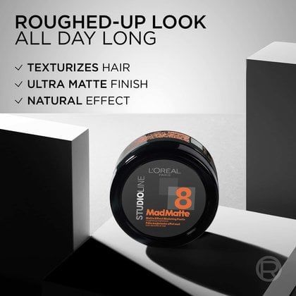 Close-up of the Studio Line product container with text highlighting "ROUGHED-UP LOOK ALL DAY LONG", "TEXTURIZES HAIR", "ULTRA MATTE FINISH", and "NATURAL EFFECT".